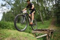 Orel, Russia, June 15, 2019: redBike Cup cross country cycle XCO competition. Young man making bike jump from wooden ramp