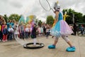 Orel, Russia, May 26, 2019: Twin Festival. Woman in bright unicorn costume making huge soap bubble over little girl