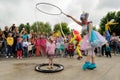 Orel, Russia, May 26, 2019: Twin Festival. Woman in unicorn costume entertaining children with soap-bubbles