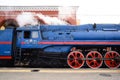 Orel, Russia, September 28, 2018: Black old steam Soviet locomotive P36 serries locomotive with red wheels in railway station