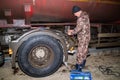 A car electrician repairs the wiring of a truck