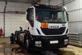 The Iveco truck tractor is undergoing maintenance at a service station