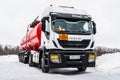 Oil tanker truck with a tank semi-trailer in a parking lot in winter