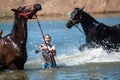 Orenburg, Russia - 18 June 2016: Girl bathing horses