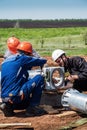 Workers on a construction site assembling a wind turbine rotor before installation Royalty Free Stock Photo