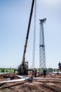 Workers-slingers on a construction site prepare a wind turbine rotor for lifting with a crane Royalty Free Stock Photo