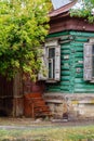 An old log house with platbands and shutters, and wooden steps Royalty Free Stock Photo