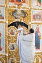 Orenburg, Russian Federation-2 Aprel 2019. Orthodox priest holding a baby during the baptism ritual