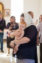 Orenburg, Russian Federation-2 Aprel 2019. Woman holding a baby during the baptism ritual