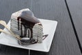 Oreo crepe cake with chocolate in white dish on wooden table Royalty Free Stock Photo