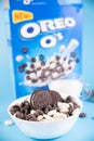 Oreo Flavored Breakfast Cereal, black and white dry breakfast rings. Cup with delicious breakfast and milk