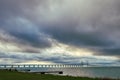 The Oresund Bridge in the Baltic Sea against a cloudy dramatic sky. The Oresundsbron or Oresundsbroen connects Sweden and Denmark