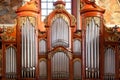 The organ in the Baroque parish church in Poznan, Poland. Fragment of the instrument. Royalty Free Stock Photo