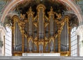 Organ in a church with silver pipes and golden ornaments Royalty Free Stock Photo
