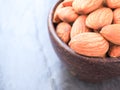 Organic almonds seeds in a wooden bowl. Royalty Free Stock Photo