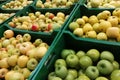 Organic apples in plastic boxes in the supermarket are sorted by varieties. fresh apples store background. Fruits in the pallets Royalty Free Stock Photo