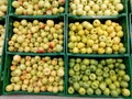 Organic apples in plastic boxes in the supermarket are sorted by varieties. fresh apples store background. Fruits in the pallets