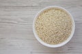 Organic Arborio rice in a white bowl on a white wooden background, top view. Flat lay, overhead, from above. Copy space Royalty Free Stock Photo