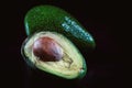 Organic avocados on a black table, close up, macro photography Royalty Free Stock Photo