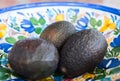 Organic avocados 3 full ones in a ceramic salad bowl Royalty Free Stock Photo