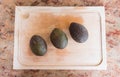 Organic avocados full on a wooden cutting-board Royalty Free Stock Photo