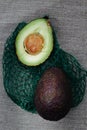 Organic avocados on a green grid Royalty Free Stock Photo