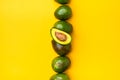 Organic avocados half cut with seed and whole fruit on yellow table background.Healthy super foods for diet.Fresh vegetable from Royalty Free Stock Photo