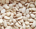 Organic background made of peeled almonds close-up, top view Royalty Free Stock Photo