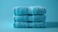 organic bamboo fiber washcloths stacked on blue color background, showcasing sustainable bathing alternatives