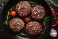 Organic beef hamburger patties with spices in a frying pan. Top view