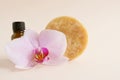Organic bio homemade handmade soap with essential oils. In the foreground is a pink orchid flower, in the background is a bottle Royalty Free Stock Photo