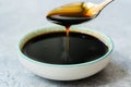 Organic Black Cane Sugar Molasses Dripping from Spoon Royalty Free Stock Photo