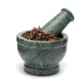 Organic black clove (Syzygium aromaticum) on marble pestle. Royalty Free Stock Photo