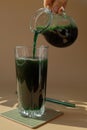 Organic blue-green algae spirulina detox drink in glass powder food. Health protein cocktail smoothie of chlorella Royalty Free Stock Photo