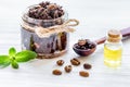 Body scrub of ground coffee with oil on white table background Royalty Free Stock Photo