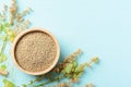 Organic brown quinoa seed in a wooden bowl