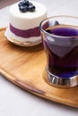 Organic Butterfly pea, clitoria or Blue pea flower herbal tea. Thai blue tea. served with   blueberry cake on wooden tray. close Royalty Free Stock Photo