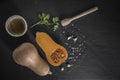 organic butternut squash with spices and ingredients for making on a black slate Royalty Free Stock Photo