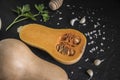 organic butternut squash with spices and ingredients for making on a black slate Royalty Free Stock Photo