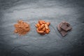 Organic cacao beans, cacao powder and chocolate on a black stone background Royalty Free Stock Photo