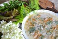 Organic calves-foot, meat aspic on village table in vintage style. Spinach, basil and lettuce leaves