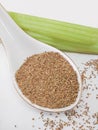 Organic celery seeds in porcelain spoon. celery stick. White background Royalty Free Stock Photo