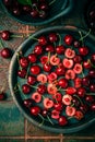 Organic cherries in bowl with baking pan on kitchen table Royalty Free Stock Photo