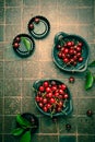 Organic cherries in bowl with baking pan on kitchen table Royalty Free Stock Photo
