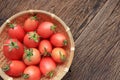 organic cherry tomato in basket on old wooden boards. Royalty Free Stock Photo