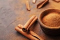 Organic cinnamon sticks and powder on brown rustic background. Aromatic spices. Royalty Free Stock Photo