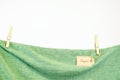 Organic clothes. Green t-shirt hanging on a clothesline.