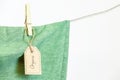 Organic clothes. Green t-shirt hanging on a clothesline.