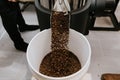 Organic Coffee Beans Roasting in an Industrial Coffee Bean Roaster and Cooling on Mechanical Stirring Pan