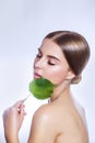 Organic cosmetic . Beautiful woman face portrait with green leaf , concept for skin care or organic cosmetics Royalty Free Stock Photo